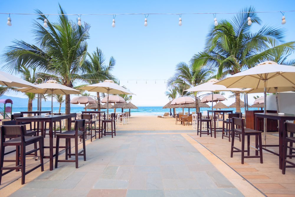 photo of empty cafe on the beach at tropical sea