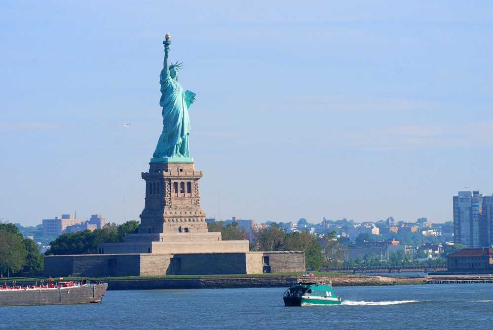 New York City Statue of Liberty with boat in Manhattan over Hudson River