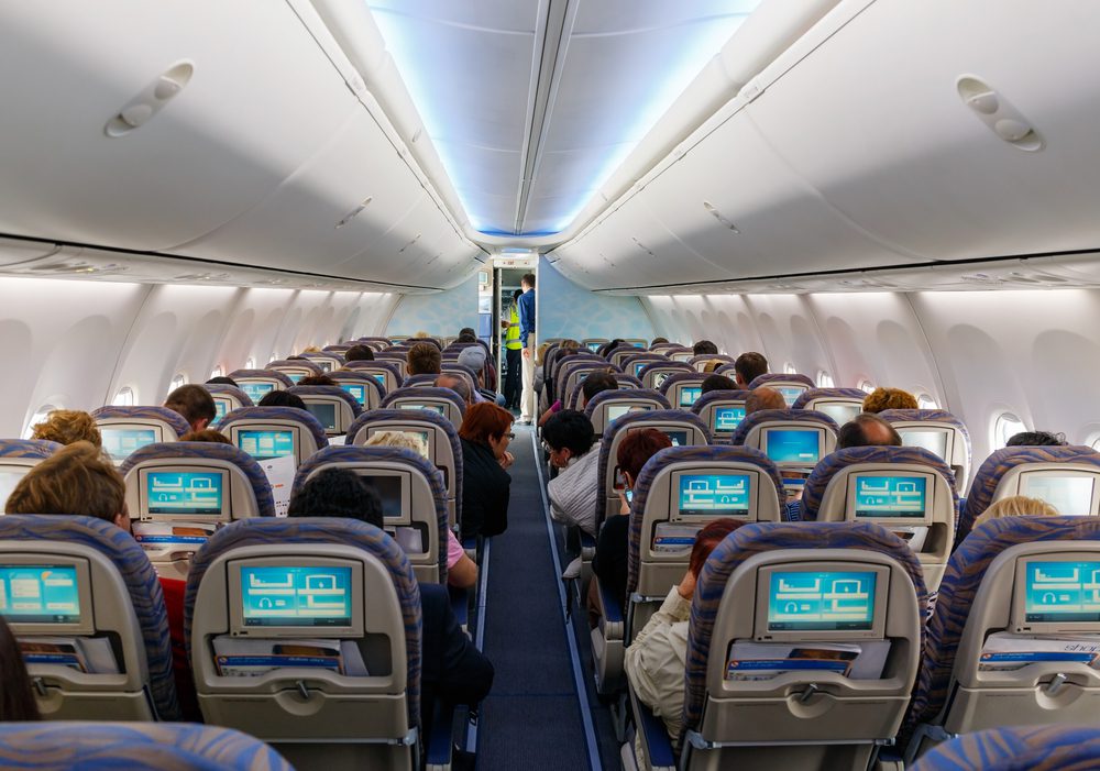 Passengers sitting on their chairs in airplane cabin