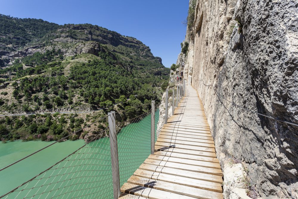 Hiking trail 'El Caminito del Rey' - King's Little Path, former world's most dangerous footpath Ardales, Malaga province, Spain, wooden path with mountain on the right and water to the left