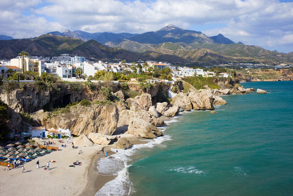 Scenic resort town of Nerja with small sandy beach on Costa del Sol by the Mediterranean Sea in Spain, southern Andalusia region, Malaga province.