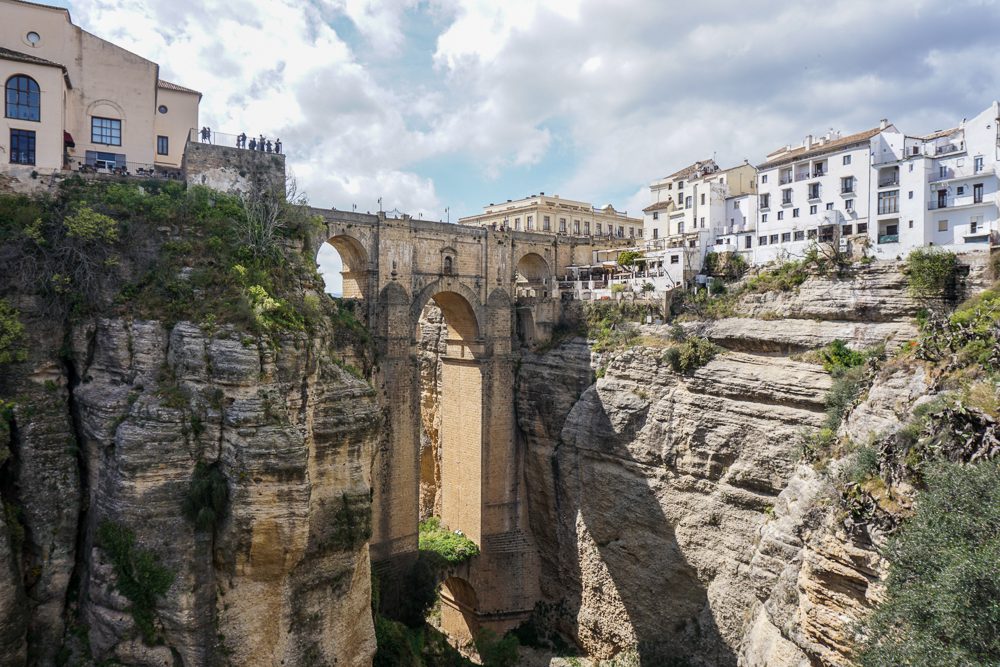 Ronda Spain view of the new bridge and the canyon below. The white buildings of the town are on the cliff