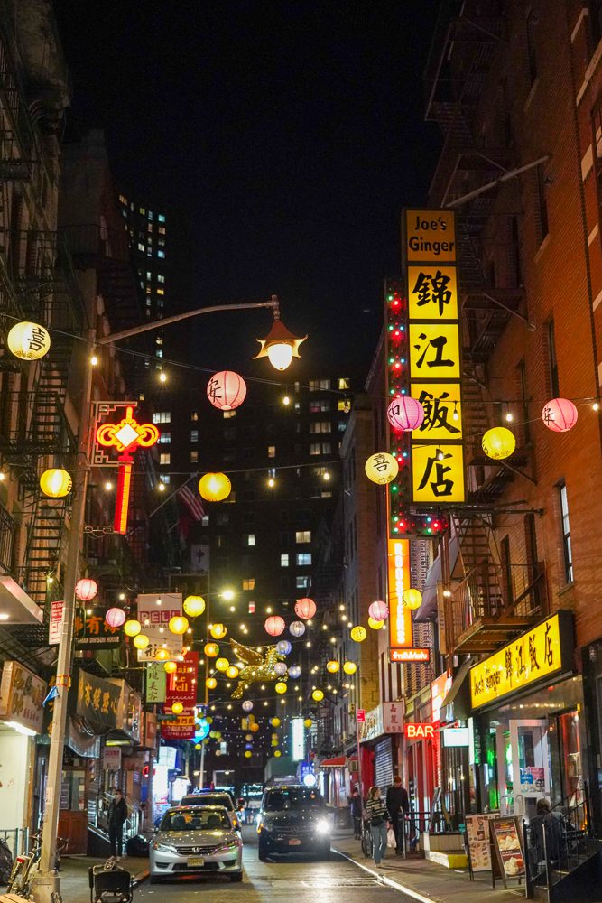Pell Street Chinatown NYC at night with the lanterns over the street lit.