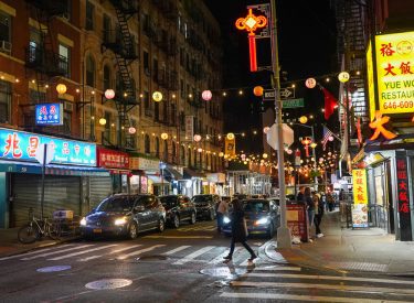 Chinatown NYC street at night with the lanterns lit.
